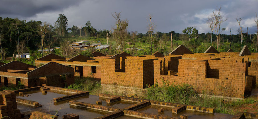 Unfinished housing that the mining company funded by a World Bank project in Liberia had promised to the people it displaced.